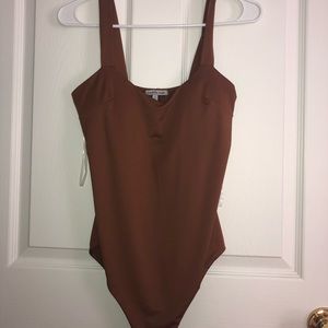 A tan brown body suit